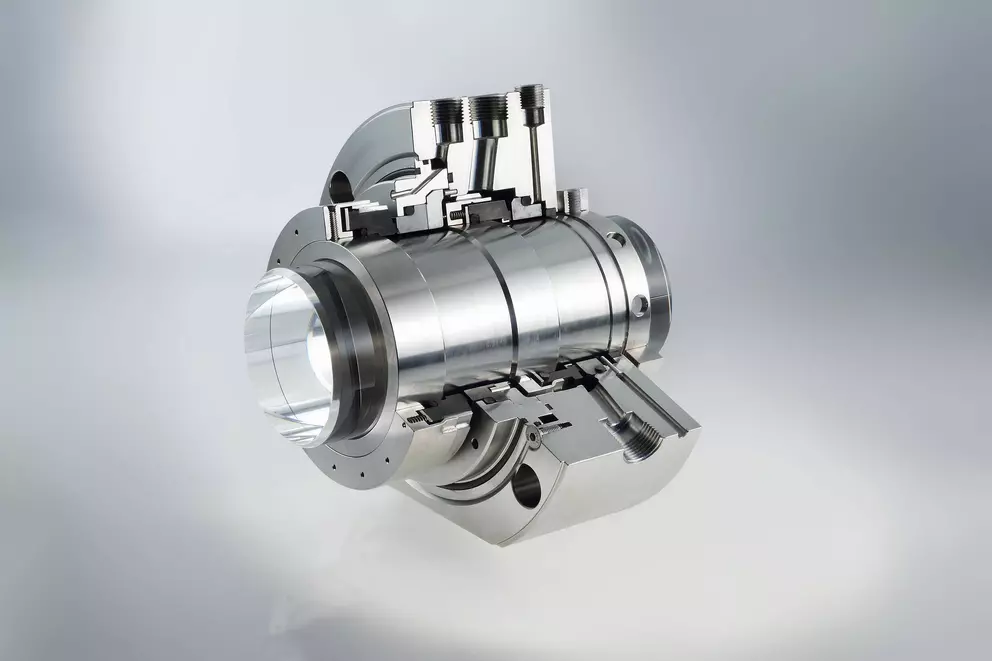 A detailed cutaway view of a metallic mechanical seal or a fluid coupling, showing the internal precision-machined surfaces and threaded connections.