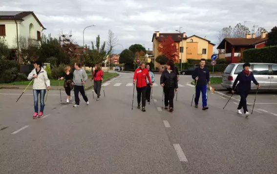 EagleBurgmann Italy employees participating in a Nordic walking activity as part of a health and wellness program promoting exercise, proper nutrition, and awareness for an aging workforce.
