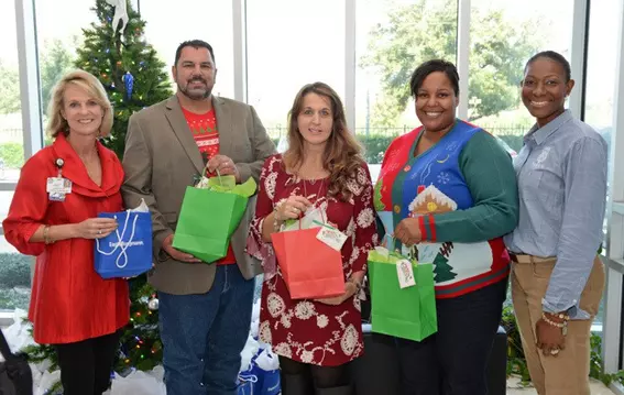 EagleBurgmann USA employees delivering holiday gift bags to support students at a Houston elementary school as part of ongoing community and education programs.