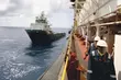 Support vessel and offshore personnel engaged in energy, maintenance, and logistics operations in a marine environment.