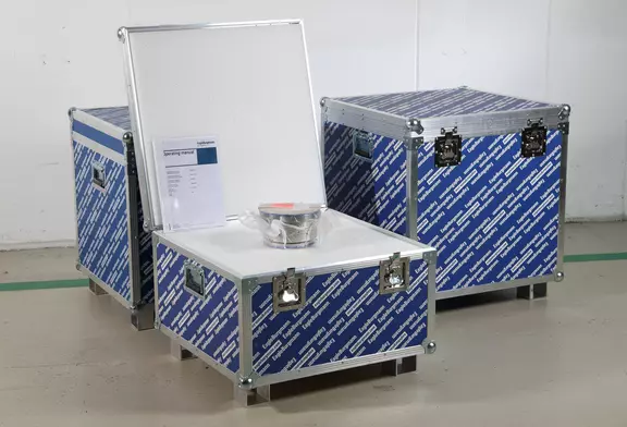 Protective transport cases with EagleBurgmann branding, one open to show a mechanical seal and operating manual inside, prepared for safe shipment and installation support.