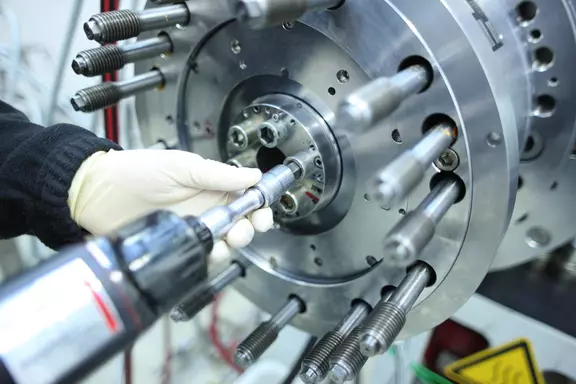 Close-up of a technician performing precise installation work on a mechanical seal for industrial machinery, ensuring reliable sealing performance.