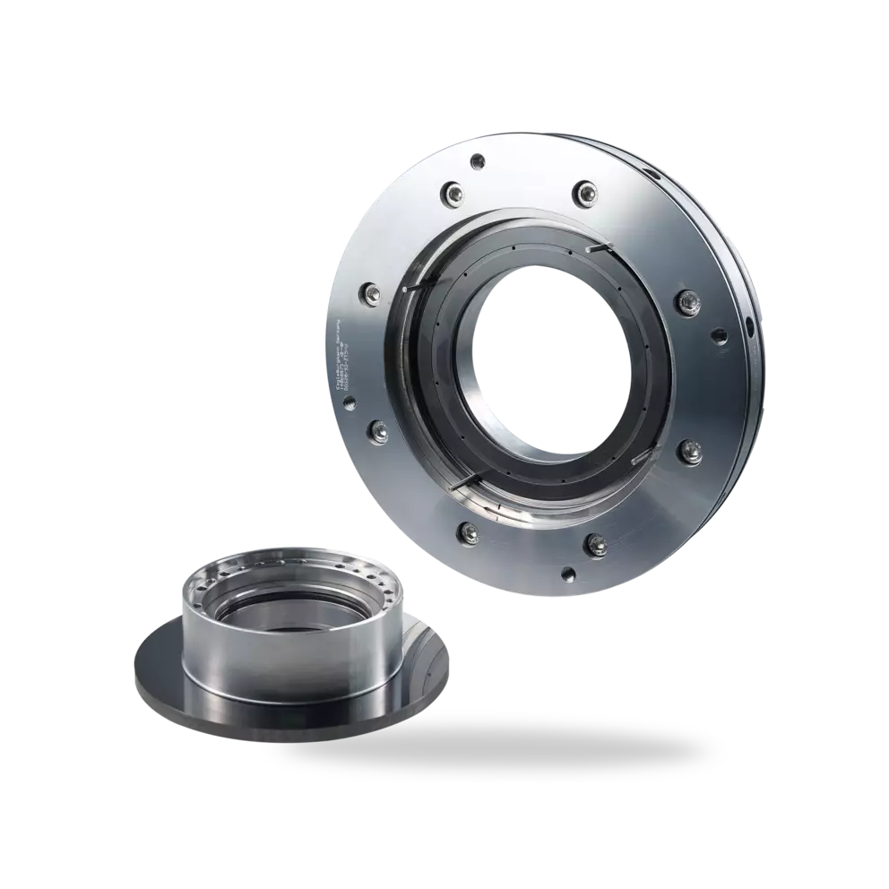 A close-up studio shot of a disassembled, high-precision metallic mechanical seal, showing the larger bolted housing and a smaller, separate sealing ring component.