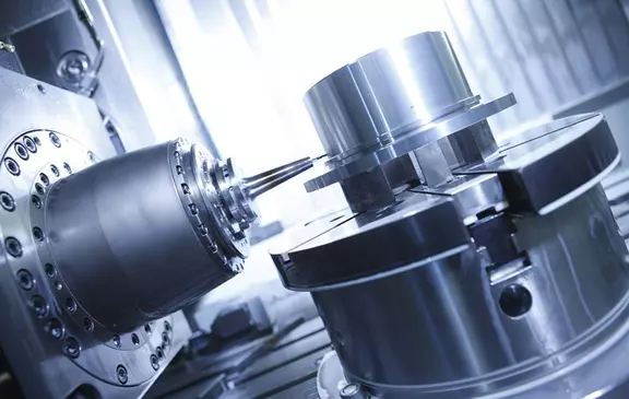 High-precision CNC milling machine machining a metallic workpiece.