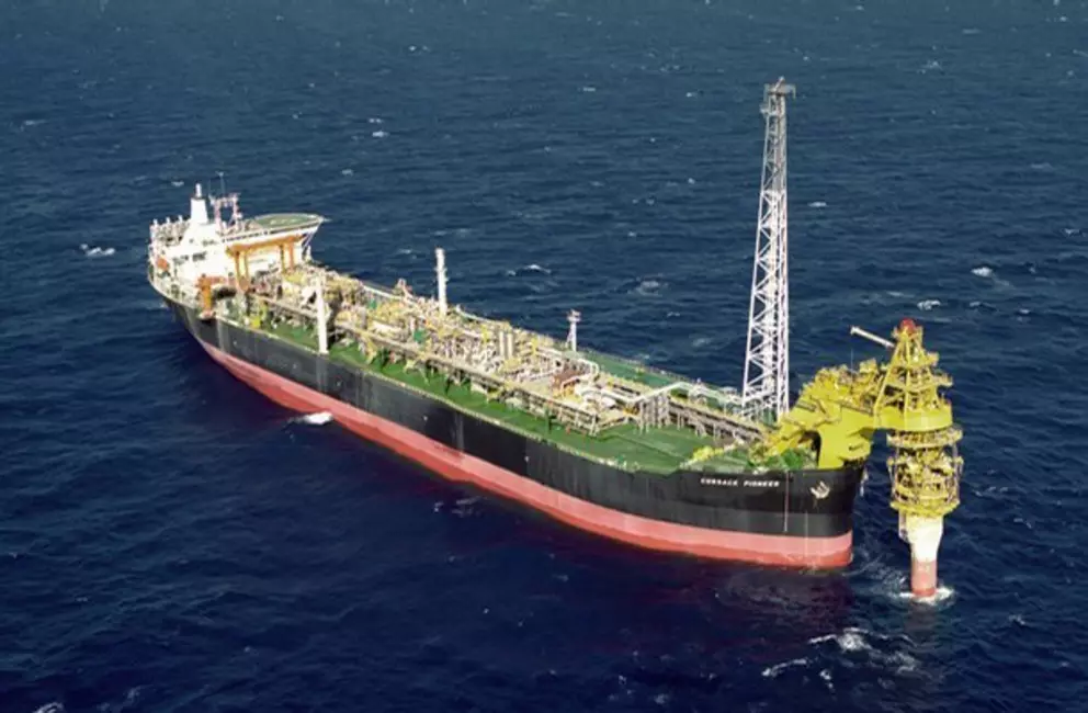 Offshore production vessel at sea with industrial processing equipment.