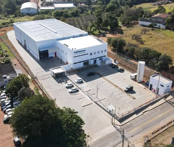 Aerial view of the EagleBurgmann facility in Brazil with warehouse space, office area, parking lot, and fenced industrial site.