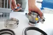 Engineer assembling mechanical seal components with precision tools in an industrial workshop.