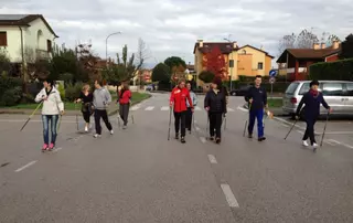 EagleBurgmann Italy employees participating in a Nordic walking activity as part of a health and wellness program promoting exercise, proper nutrition, and awareness for an aging workforce.