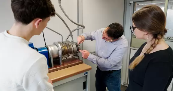 Practical technical training with a demonstration on a machine.