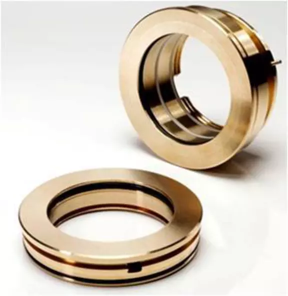 Polished bronze sealing rings for industrial machinery components on a white background.